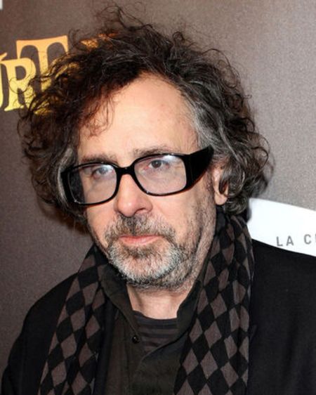 Tim Burton in a black suit and t-shirt caught in the camera.